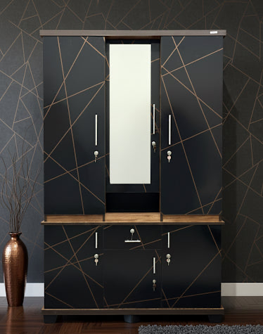 Black wardrobe with geometric design and mirror against a dark wall.