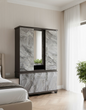 Marble-patterned cabinet in a bedroom setting with a bed and plant visible.